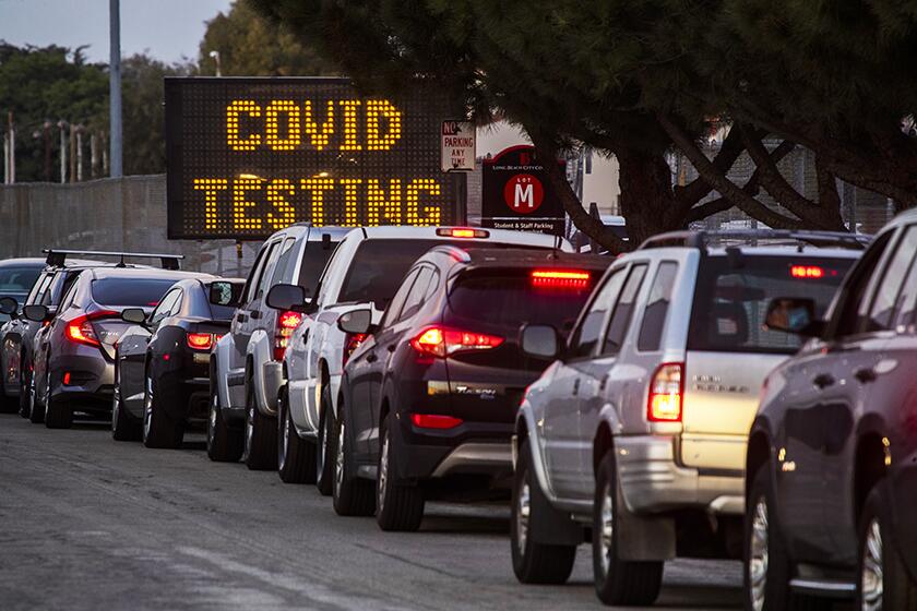 Motorists line up to take COVID-19 tests at at Long Beach City College-Veterans Memorial Stadium.