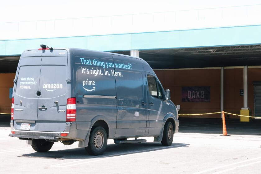 Palmdale, CA - May 05: A delivery vehicle that has been grounded from a crack in its rear light is seen near a sign that notes the distribution location, DAX8, at Johnathon Ervin's distribution site for Amazon products on Friday, May 5, 2023 in Palmdale, CA. Ervin has decided to voluntarily unionize the company and wonders if Amazon is retaliating against his company. (Dania Maxwell / Los Angeles Times).