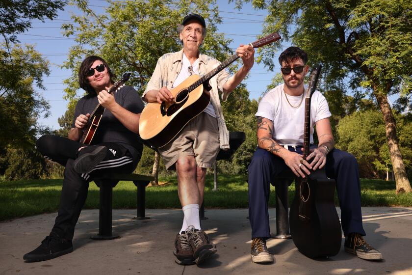 BURBANK-CA-JULY 24, 2024: Friends Justin Beverly, 26, Jose Bautista, 73, and Nicholas Baraban, 33, from left, hang out at Johnny Carson Park in Burbank on July 24, 2024. (Christina House / Los Angeles Times)