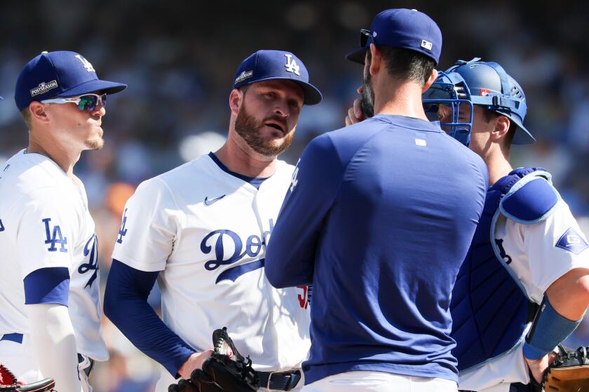 Dodgers pitching coach Mark Prior talks to pitcher Ryan Brasier against the Mets at Dodger Stadium.