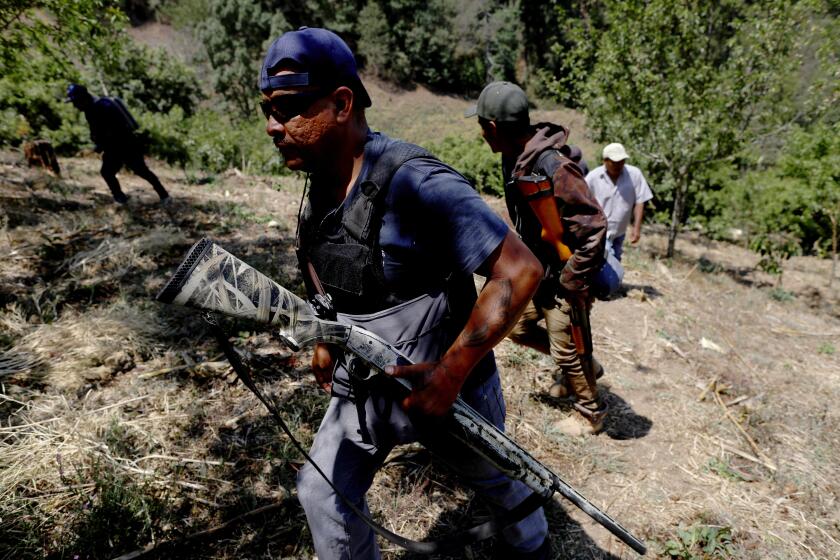 Photographs by Gary Coronado  Los Angeles Times ANDRES CASARUBIAS VEGA and other vigilante group members patrol in Filo de Caballos. They employ the same brutal tactics of their enemies, and both sides have an arsenal of U.S.-made military-style guns.