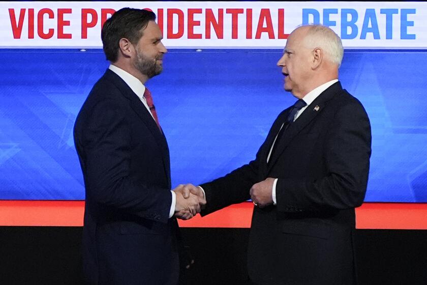 Republican vice presidential nominee Sen. JD Vance, R-Ohio, left, and Democratic vice presidential nominee Minnesota Gov. Tim Walz, shake hands as they arrive for a CBS News vice presidential debate, Tuesday, Oct. 1, 2024, in New York. (AP Photo/Julia Demaree Nikhinson)