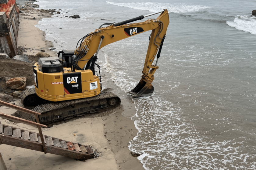 A photo of an excavator scooping sand in Broad Beach cited in the lawsuit.