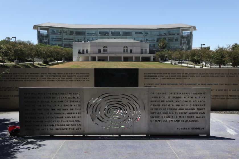 LOS ANGELES, CA - JULY 19: A memorial for Sen. Robert F. Kennedy fronts the site of what was the Ambassador Hotel, where he was assassinated in 1968. Razed in 2006, it was replaced by a complex of LAUSD public schools. A self-driving architectural tour along Wilshire Boulevard from MacArthur Park to Fairfax Avenue will show historic buildings that range in style from Neo-Gothic to Art Deco to Midcentury Modern. Photographed on Sunday, July 19, 2020 in Los Angeles, CA. (Myung J. Chun / Los Angeles Times)