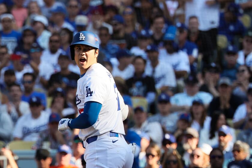 LOS ANGELES, CALIFORNIA - OCTOBER 14: Shohei Ohtani #17 of the Los Angeles Dodgers yells back while headed to first on a walk during the seventh inning in game two of the National League Championship Series against the New York Mets at Dodger Stadium on Monday, Oct. 14, 2024 in Los Angeles. (Robert Gauthier / Los Angeles Times)