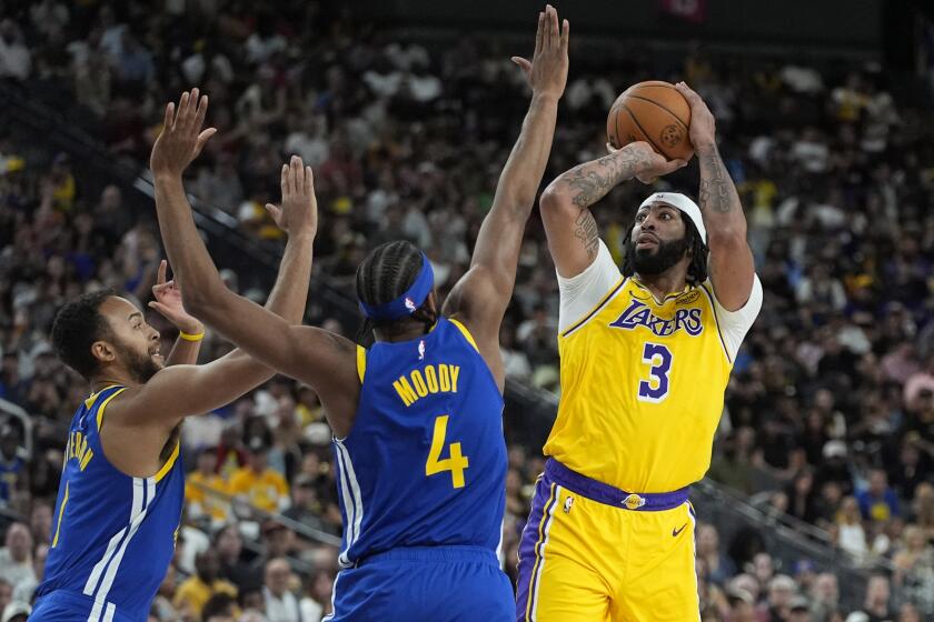 Los Angeles Lakers forward Anthony Davis (3)shoots over Golden State Warriors guard Moses Moody (4) during the first half of a NBA preseason basketball game Tuesday, Oct. 15, 2024, in Las Vegas. (AP Photo/John Locher)