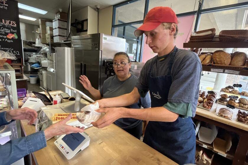 AUGURA HILL CA SEPTEMBER 12, 2024 - Patty Rivera, a barista at Emil's Bake House, center, recounts what she experienced at 7:28 Monday morning. "It started shaking and I said oh my god it's an earthquake. I was looking around and wondering what to do then it stopped." There was no damage to the business on Kanan Road in Agoura Hills. (Brian van der Brug / Los Angeles Times)